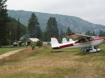 Grass Landing Strip with planes parked on side
